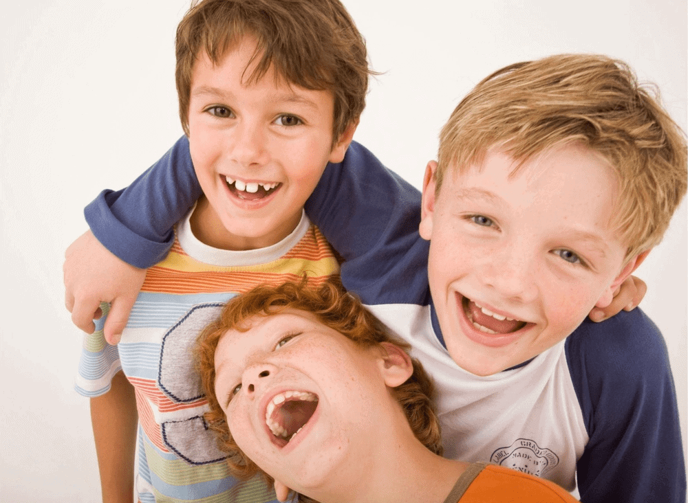 Three young boys laughing