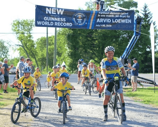 Arvid Loewen and his grandchildren at the finish line of a race.